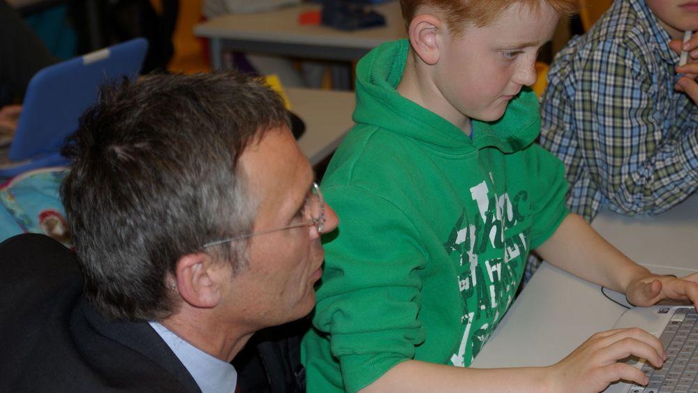 Sander Ramen i 3. klasse på Vågåmo skole viser statsminister Jens Stoltenberg hvordan en Classmate skal brukes.
